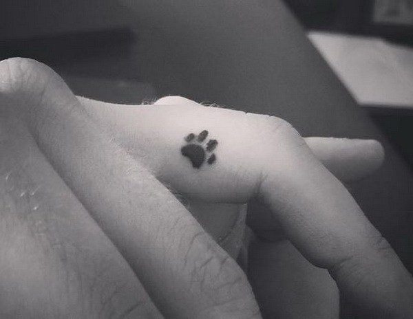Dainty Dog Paw Finger Tattoo. 