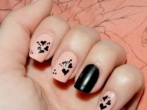 Diseño de uñas de corazón rosa y negro. 